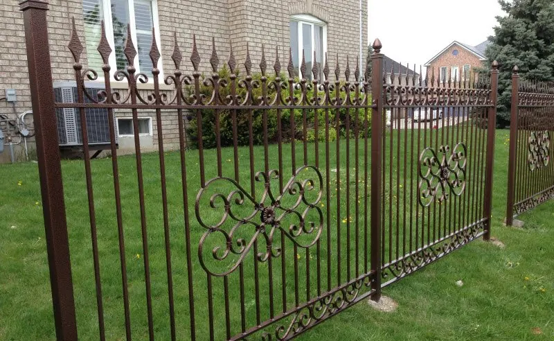 Iron fence with decorative scroll panels